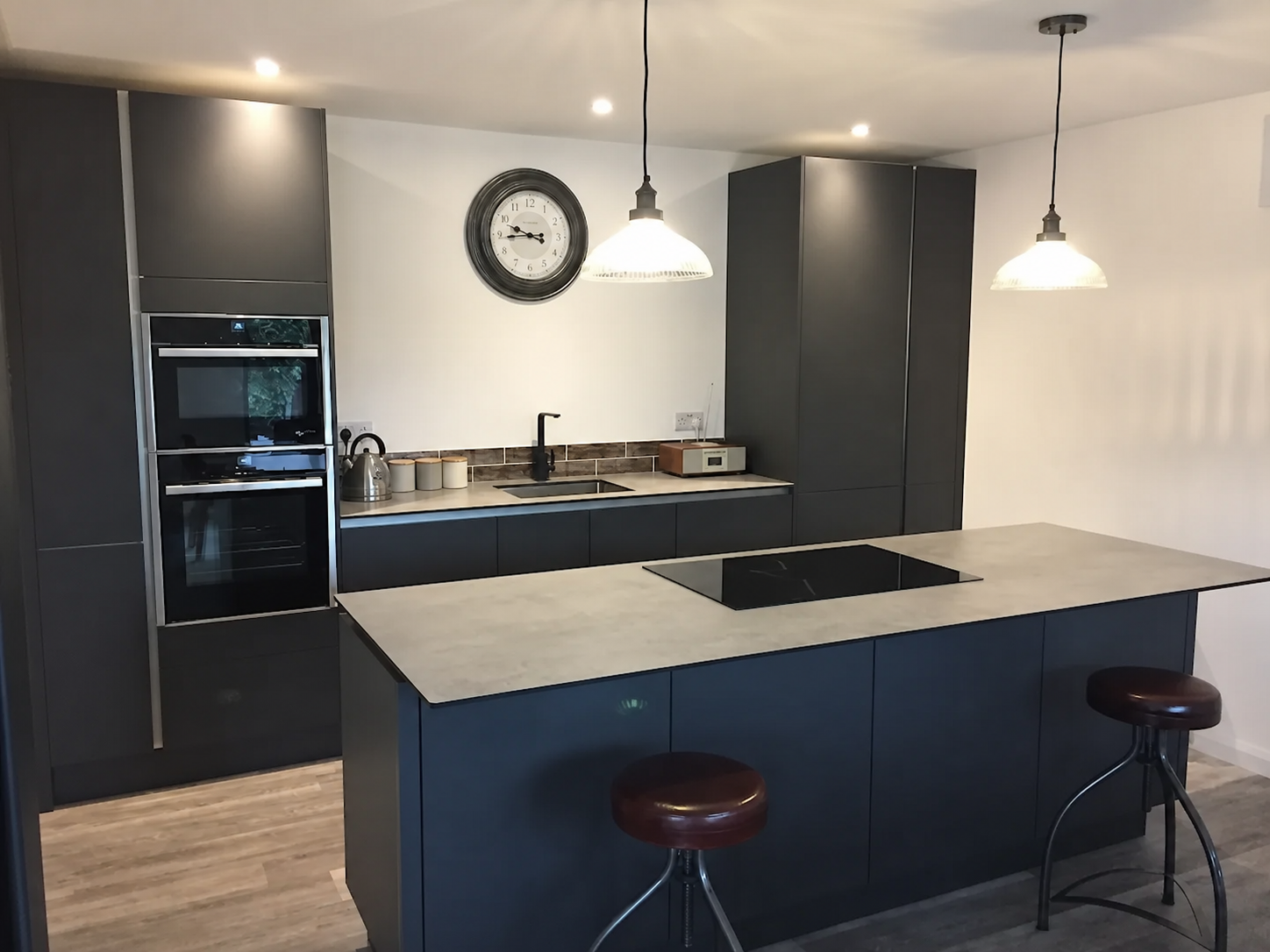 Bespoke fitted kitchen in Basildon, Essex by Jennings Renovations — anthracite handleless cabinetry with island and pendant lighting